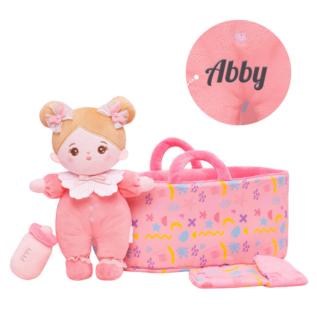 A collection of plush baby dolls in various outfits, including dresses and onesies, with one doll holding a rattle.